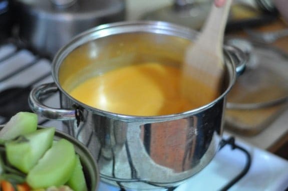 Pulique, a traditional Maya dish in Guatemala, cooking in a stainless steel pot. 