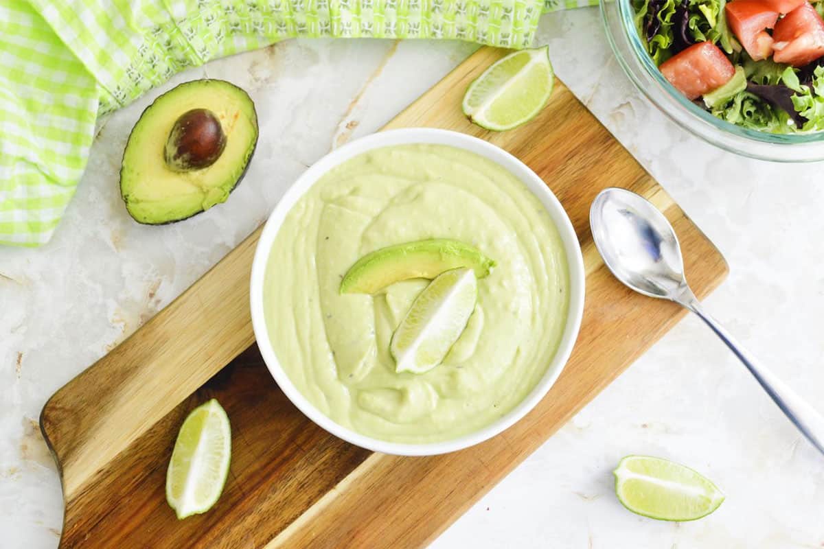 Guacamole dressing on a wooden board.