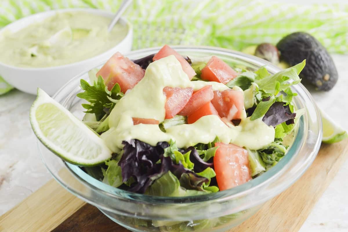 Close-up of avocado dressing on a green salad.
