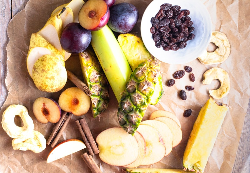 Ingredients for ponche de frutas includes dried apple, plantain, raisins, plums, cinnamon, pears and other fruit. 