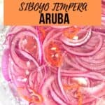Pickled onions, an Aruban traditional dish, in a clear bowl.