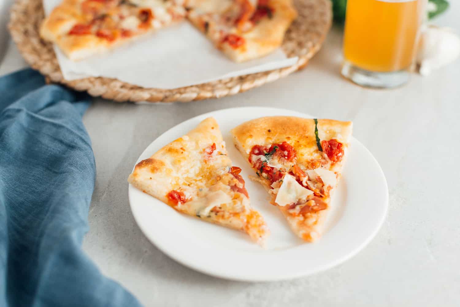 Two pieces of pizza on a white plate.