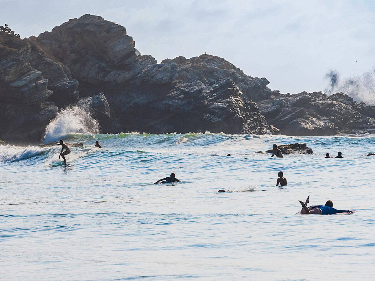 Surfers at La Punta at sunset.
