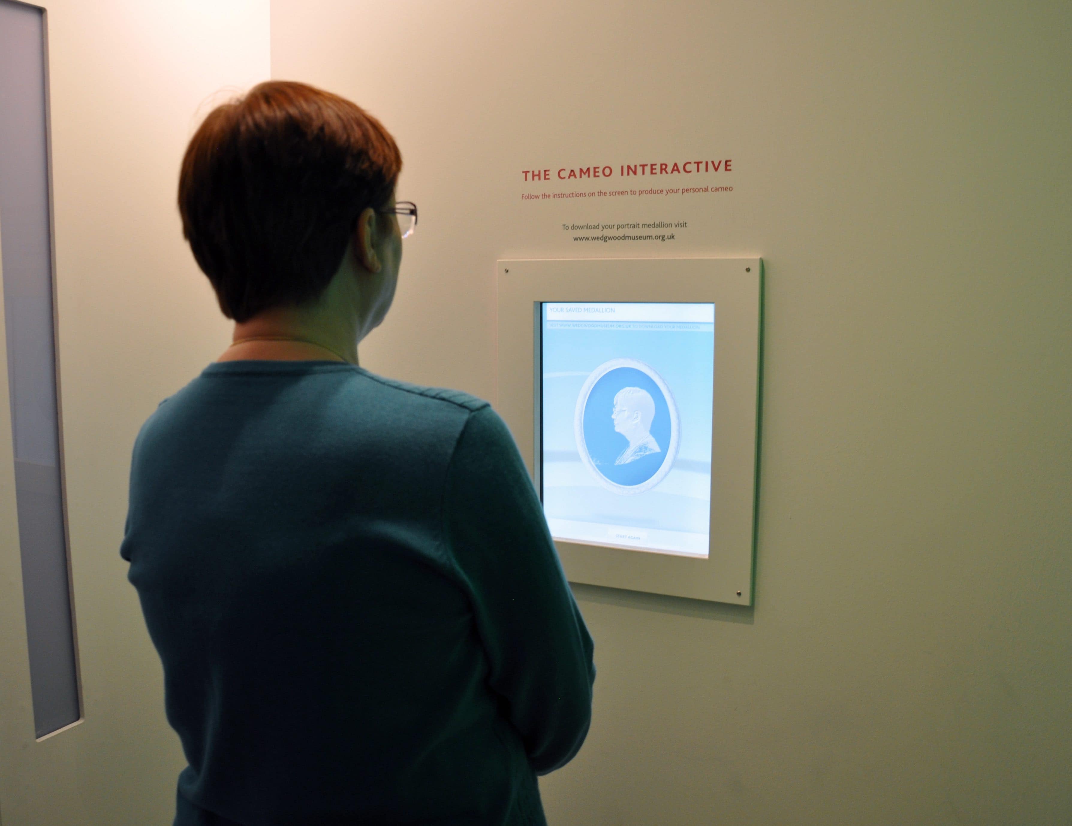 Woman creating a cameo of herself on a screen at Wedgwood World in the UK.