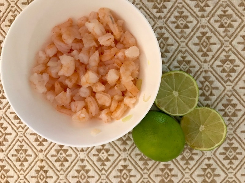 Cooked shrimp for ceviche with limes. 