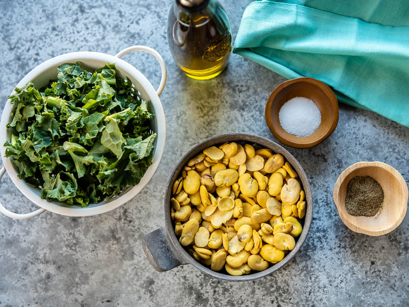 Ingredients including chicory, fava beans, salt, pepper and olive oil for Fava Bean Puree