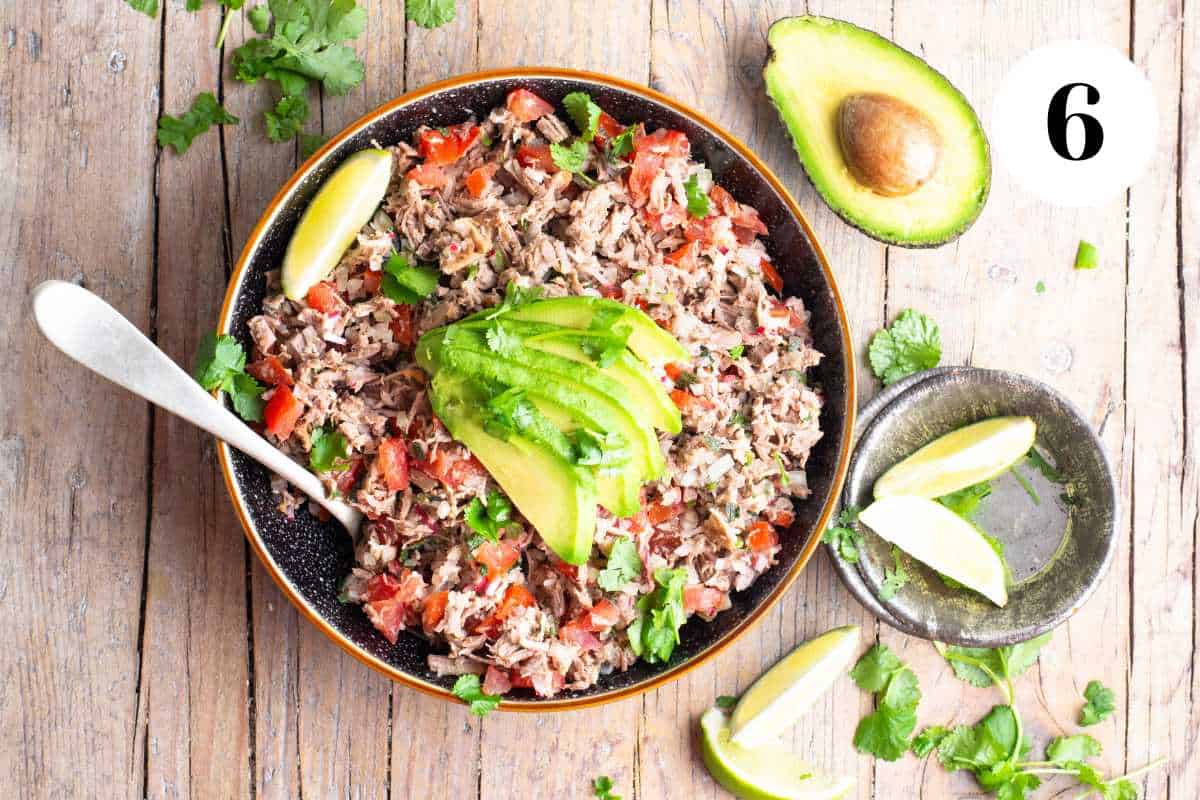 Salpicon de res in a bowl topped with avocado.