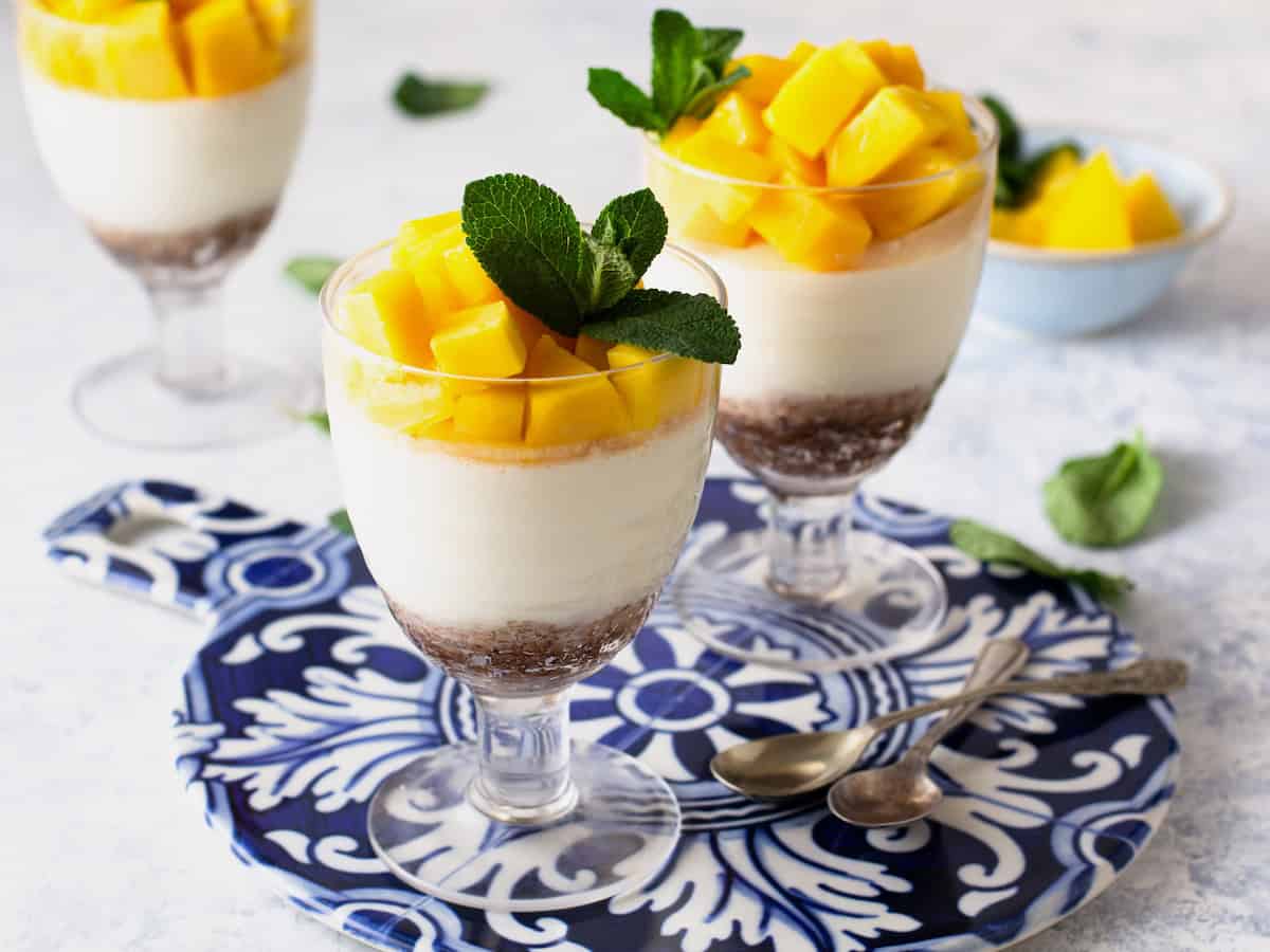 Mango Panna Cotta with a date base in a clear glass.