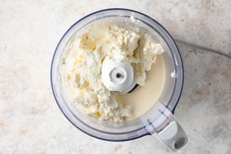 ricotta forte and cream cheese in a food processor in processor