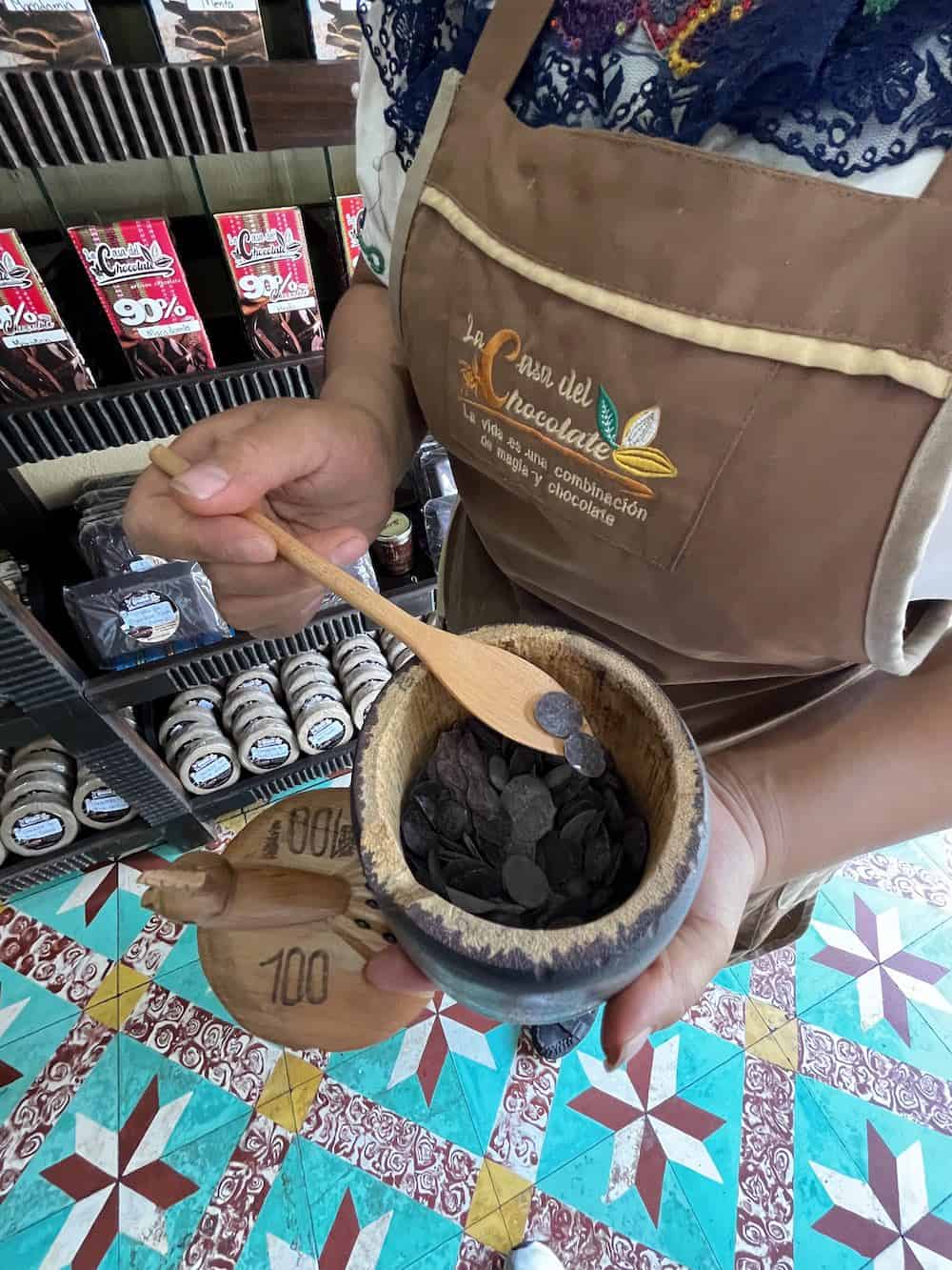 Person demonstrating products at Casa del Chocolate in Panajachel. 