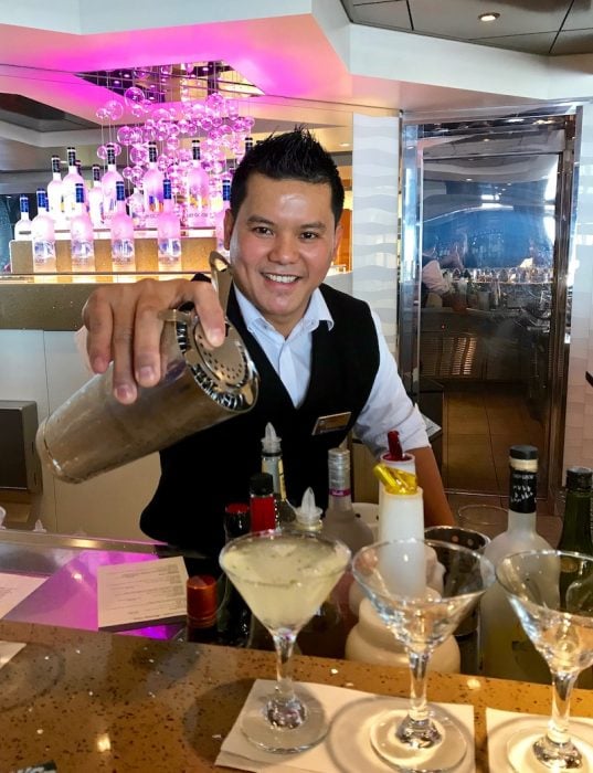 Mixologist pouring a drink in a Mixology Class aboard Holland America's MS Volendam