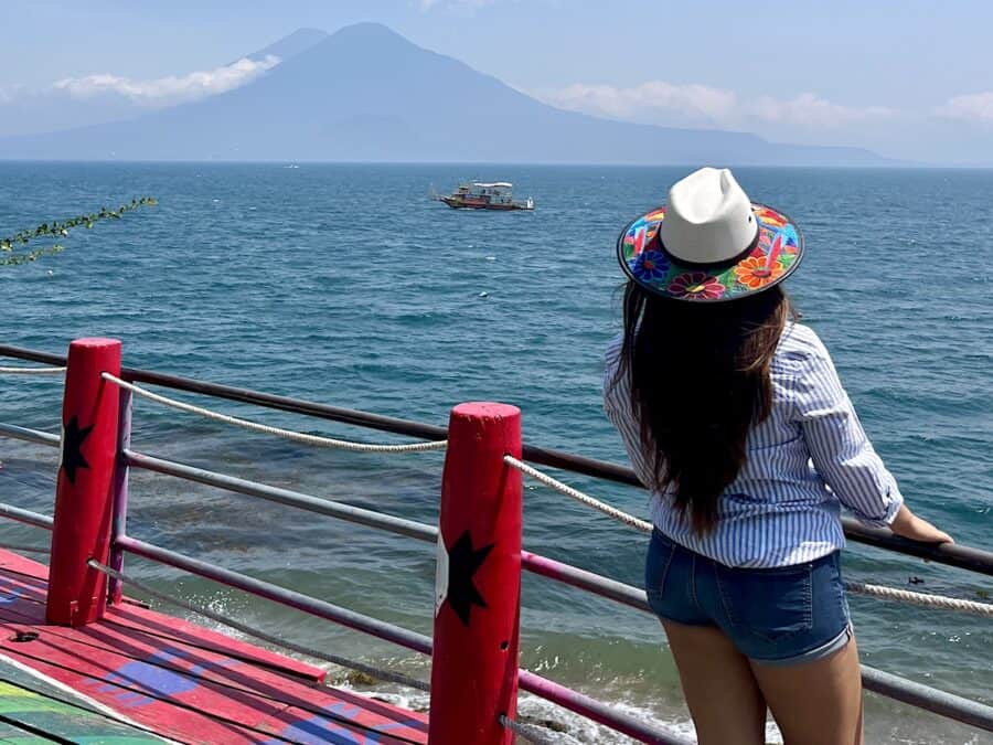 Young woman looking at Lake Atitlan in Panajachel, Solola, Guatemala.