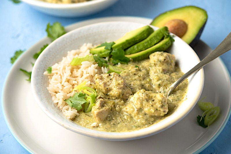 Pollo en Jocon Guatemalan Chicken and Tomatillo Stew in a white bowl.