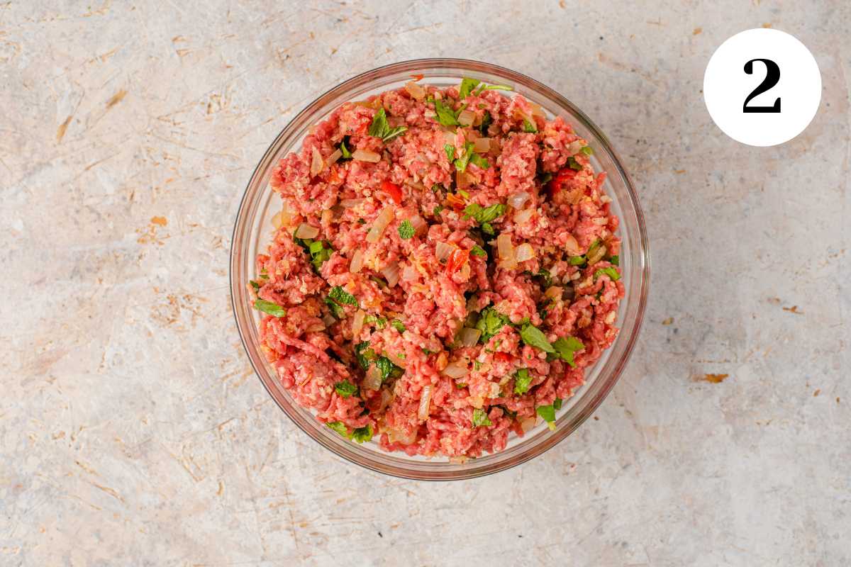 Beef mixture for Healthy Meatball Soup in a clear glass bowl. 