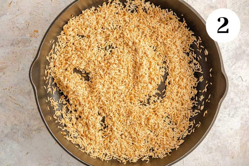 White rice browning in a skillet.