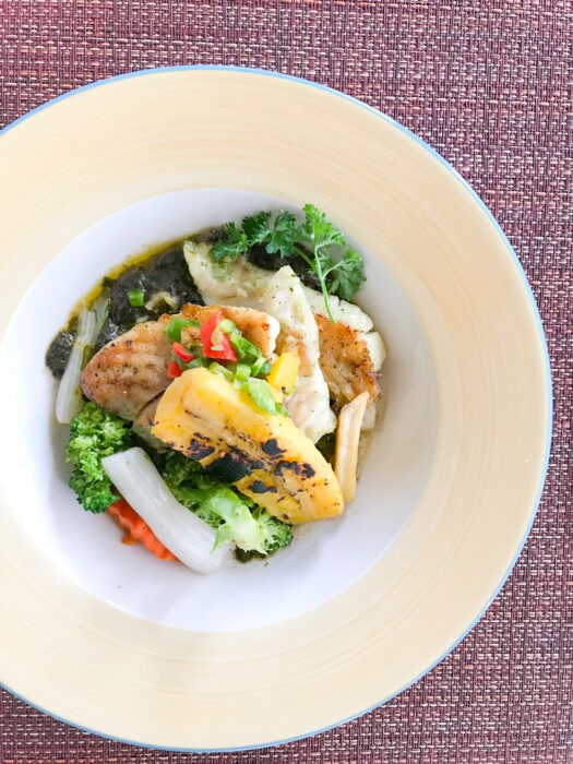 Menu at Spice Island Beach Resort includes seared snapper with callaloo puree and grilled plantain on a plate