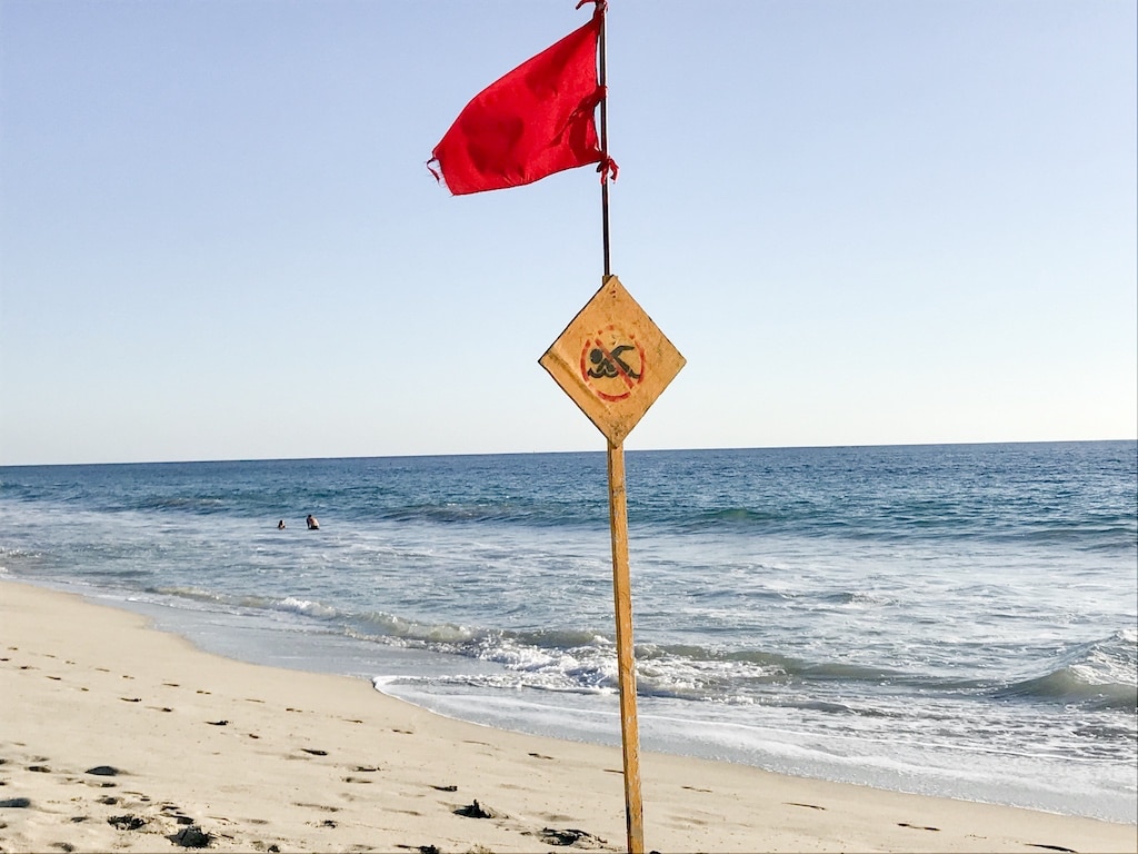 Red flag on beach in Puerto Escondido, Mexico.