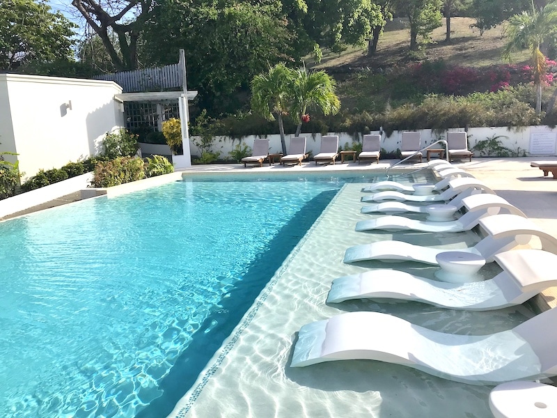 Swimming pool at Calabash Hotel on a sunny day.
