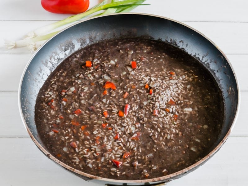 rice cooking in black bean liquid