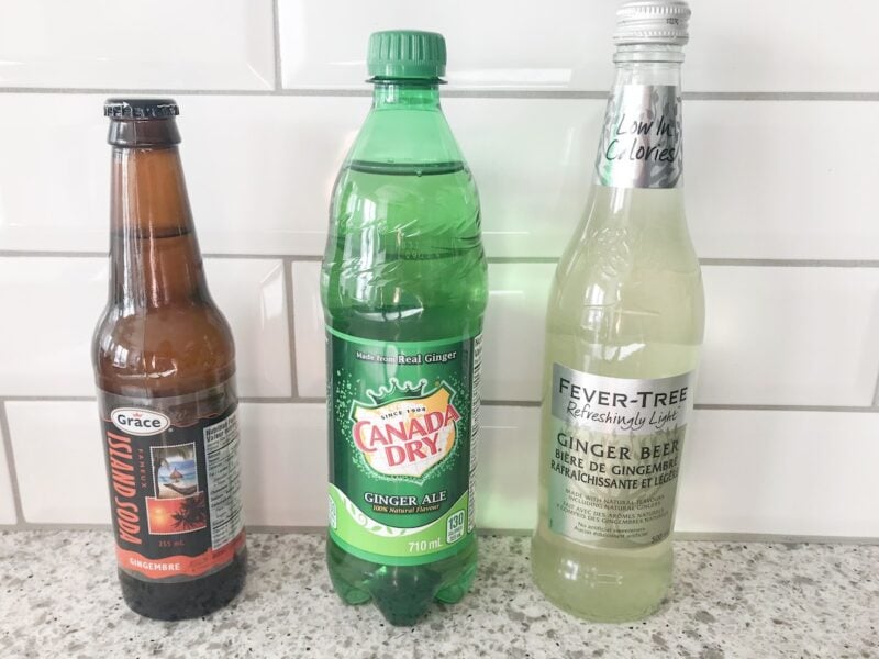 Bottle of ginger beer soda, ginger ale and ginger beer on a countertop.