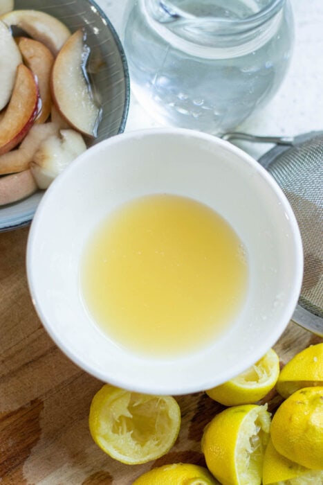 Fresh lemon juice in a white bowl.