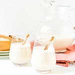 Two glasses of oat milk garnished with cinnamon