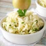 A white bowl filled with apple jicama slaw.