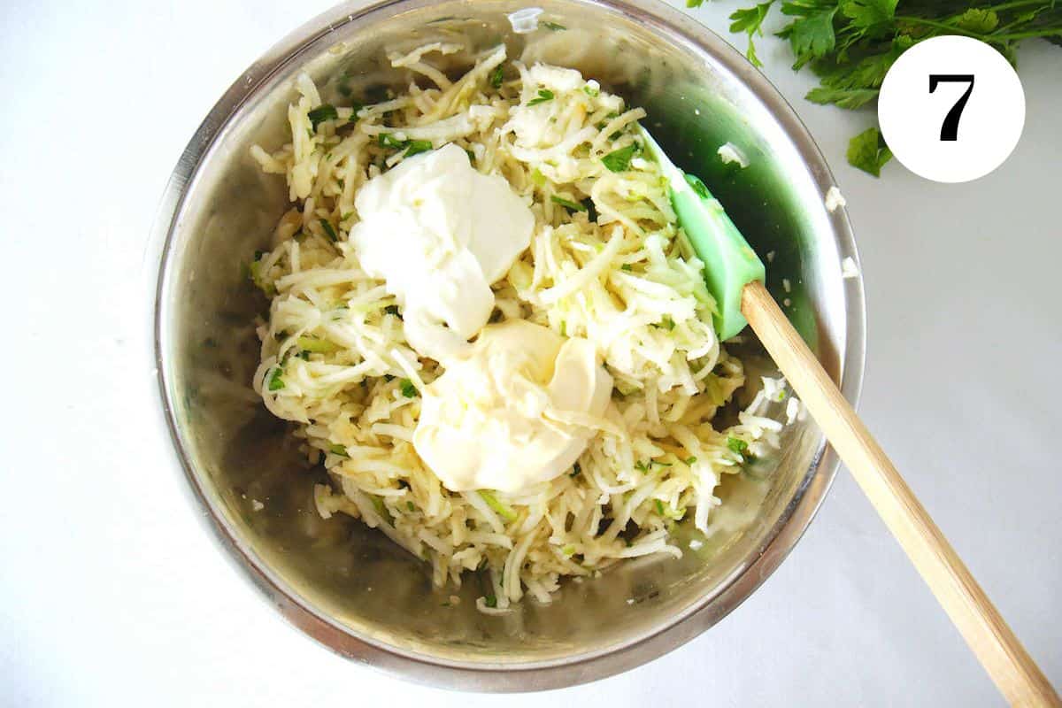 The grated apple and jicama in a bowl with the mayo and other ingredients.