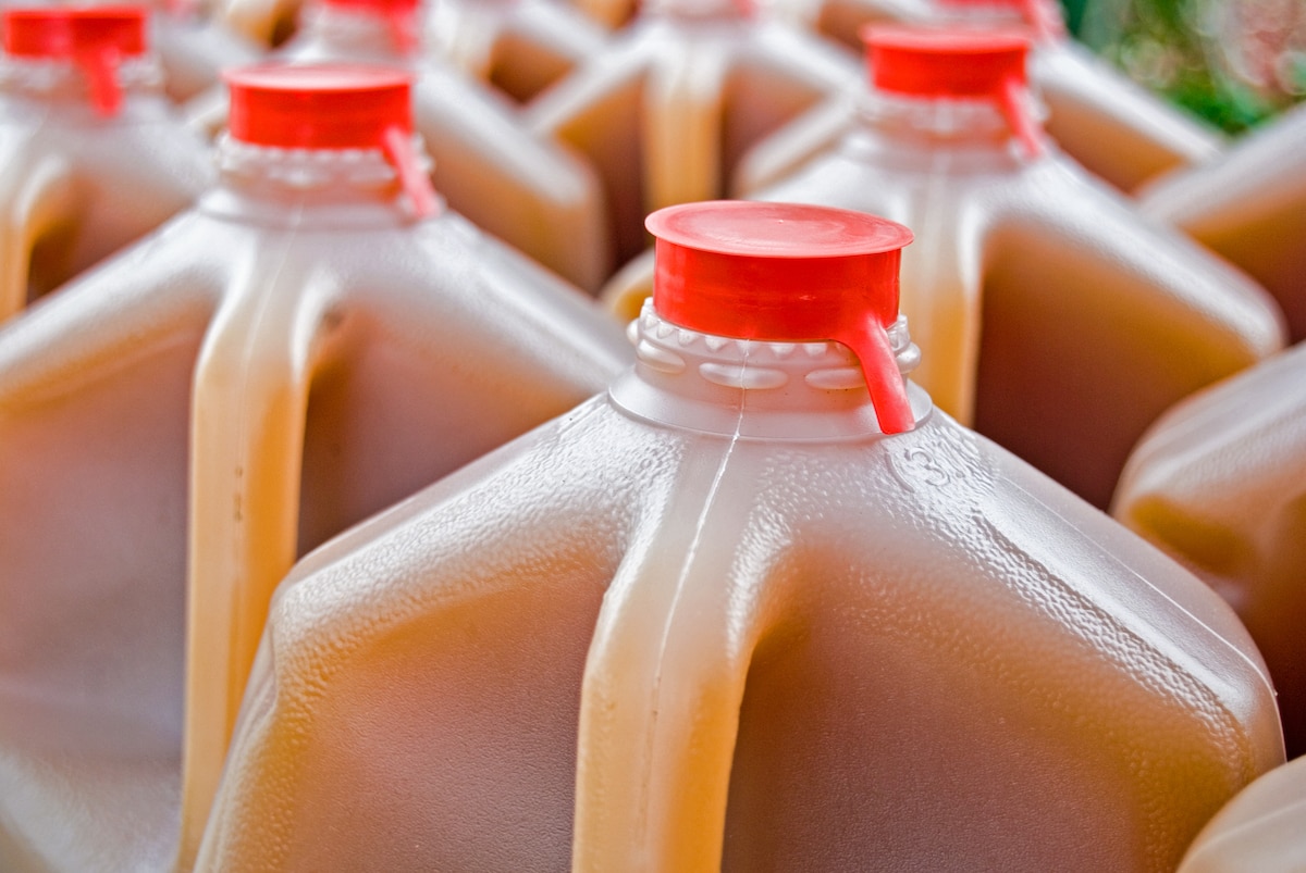 bottles of apple cider in plastic jugs 