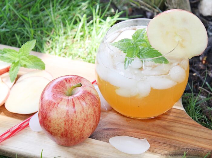 apple cider mojito with an apple on a board