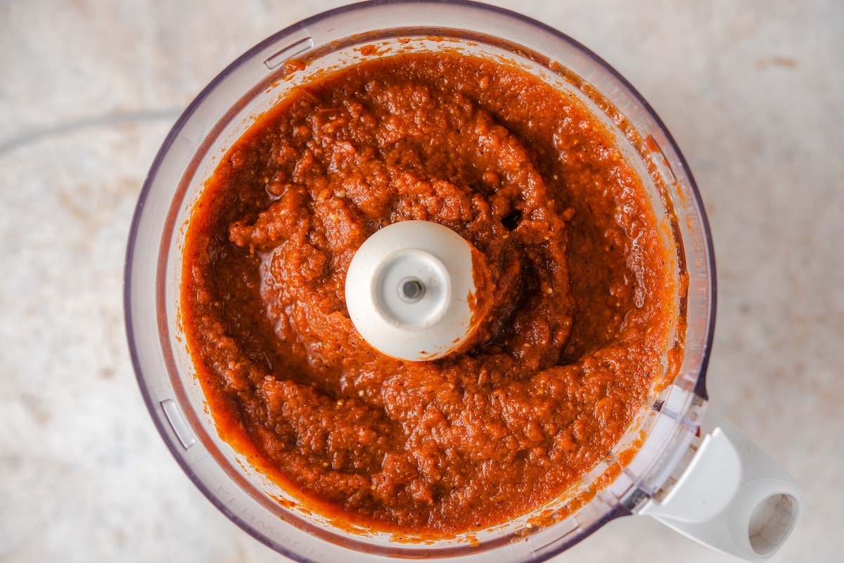 Blended vegetables and spices in a food processor for kakik turkey soup.