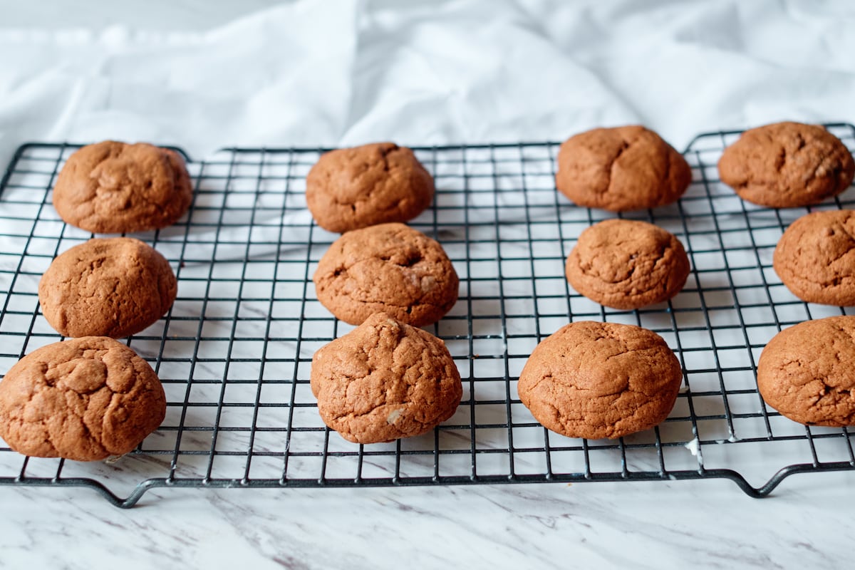 Baked drop cookies cooling on a wire rack.