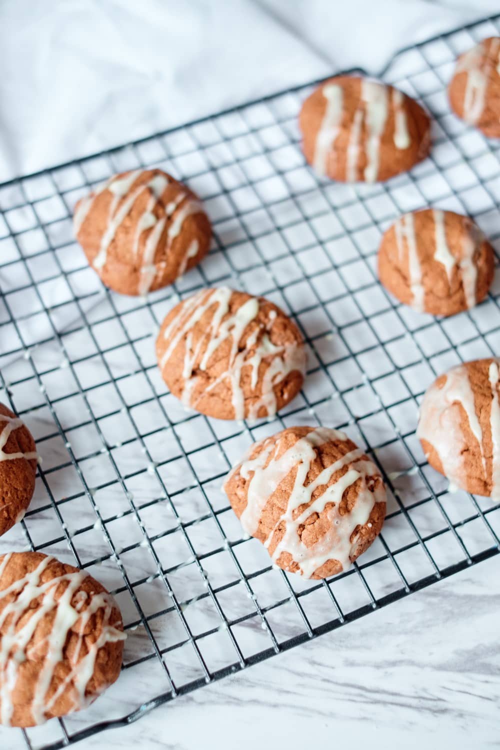 Iced cookies on rack on white background.