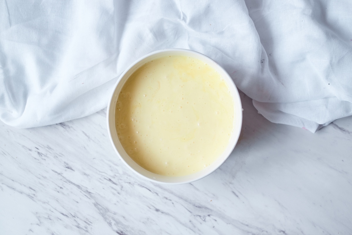 Eggnog icing in a white bowl.