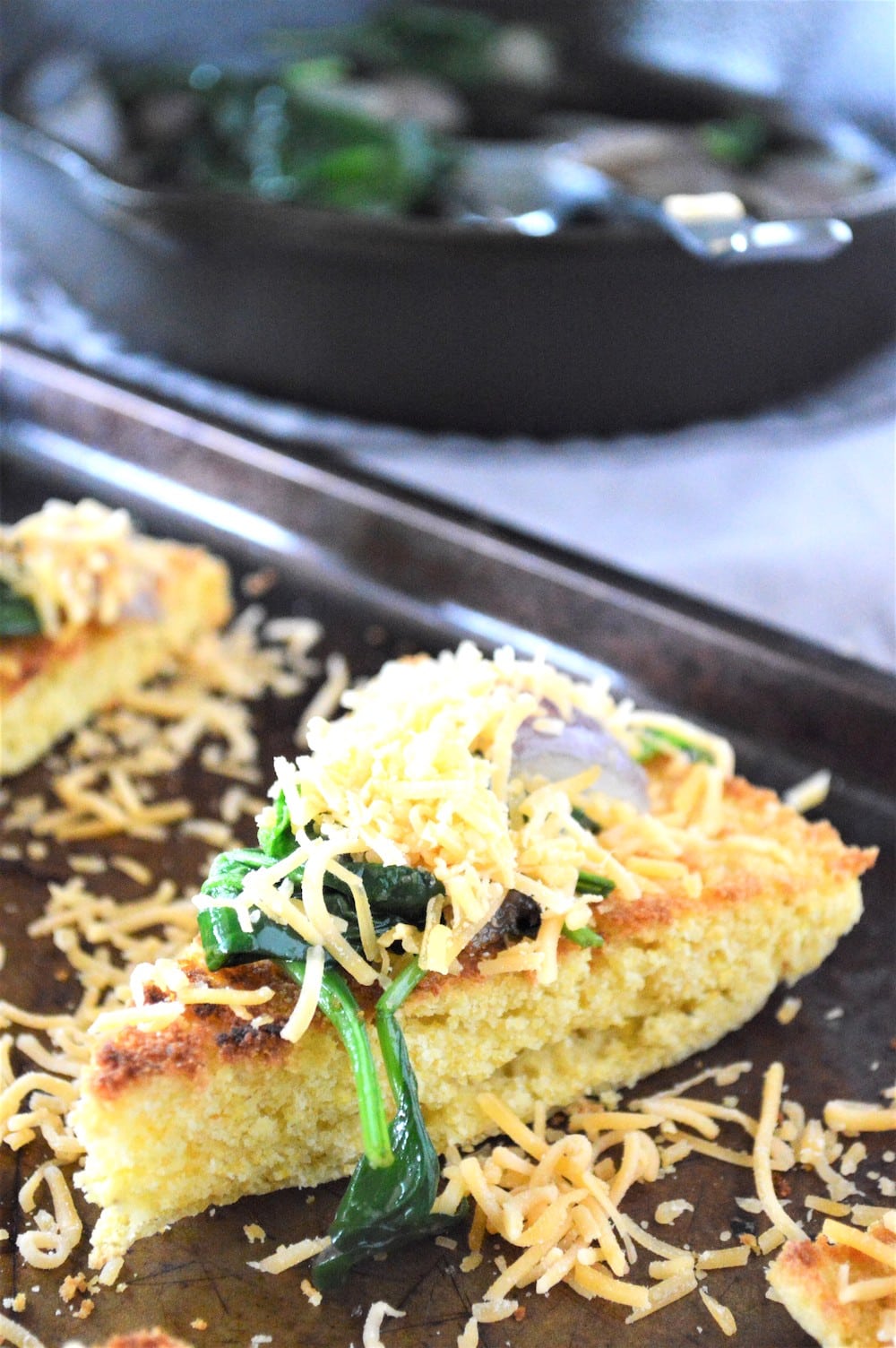 Cheddar cheese grated on toasted leftover cornbread.