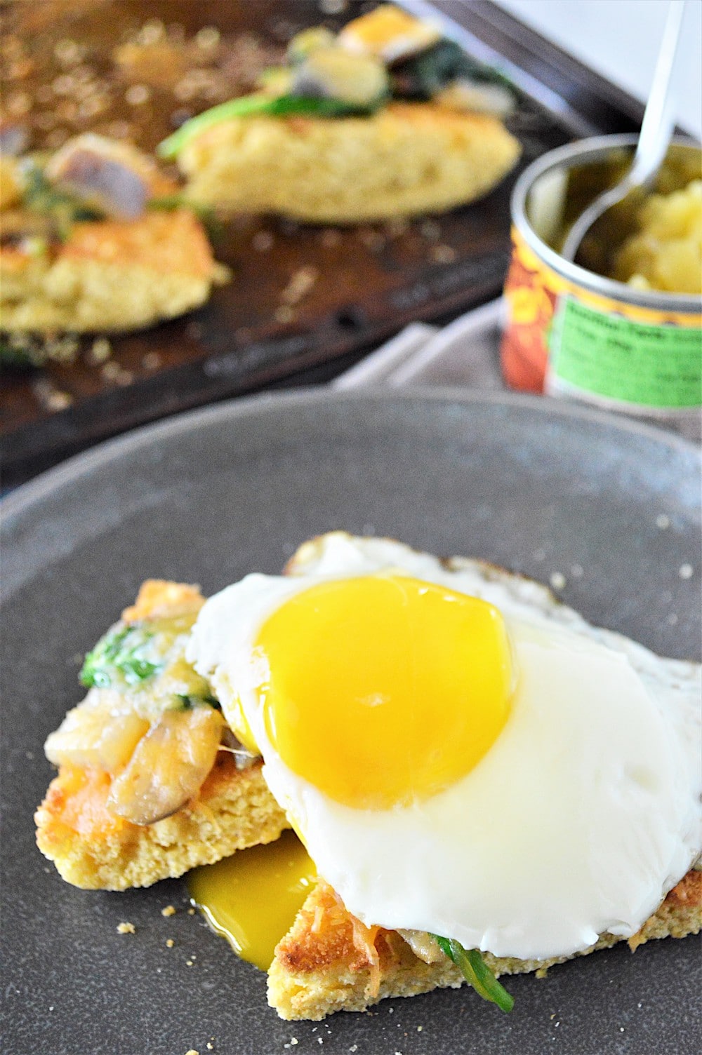 Fried egg on two pieces of toasted leftover cornbread. 