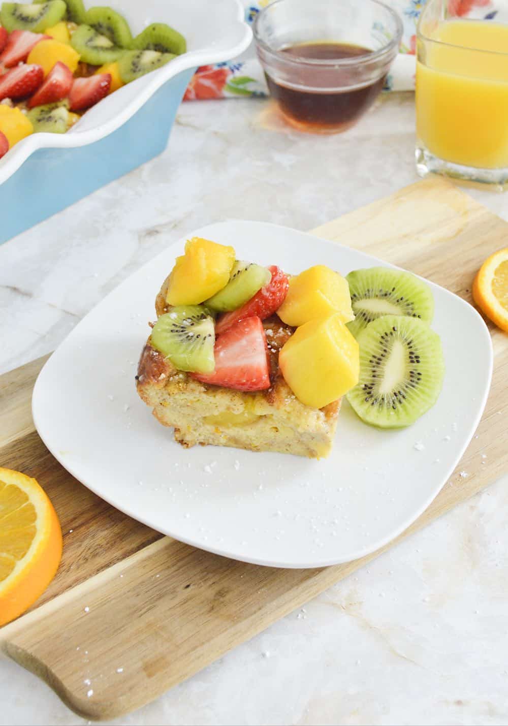 Portrait of serving of Bocado de Reina, a Guatemalan dessert, topped with fresh fruit.