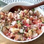 Traditional Guatemalan chojin radish and chicharrones salad in a white bowl.
