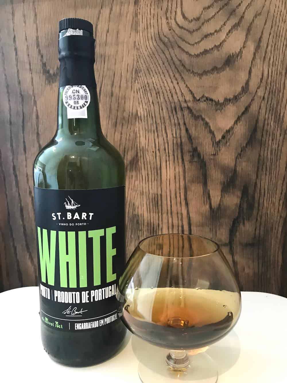 Bottle of port wine on a table with a glass.