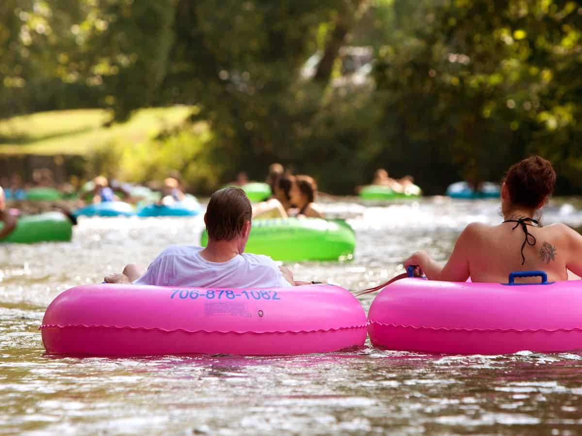 People floating on a river in the summer. 