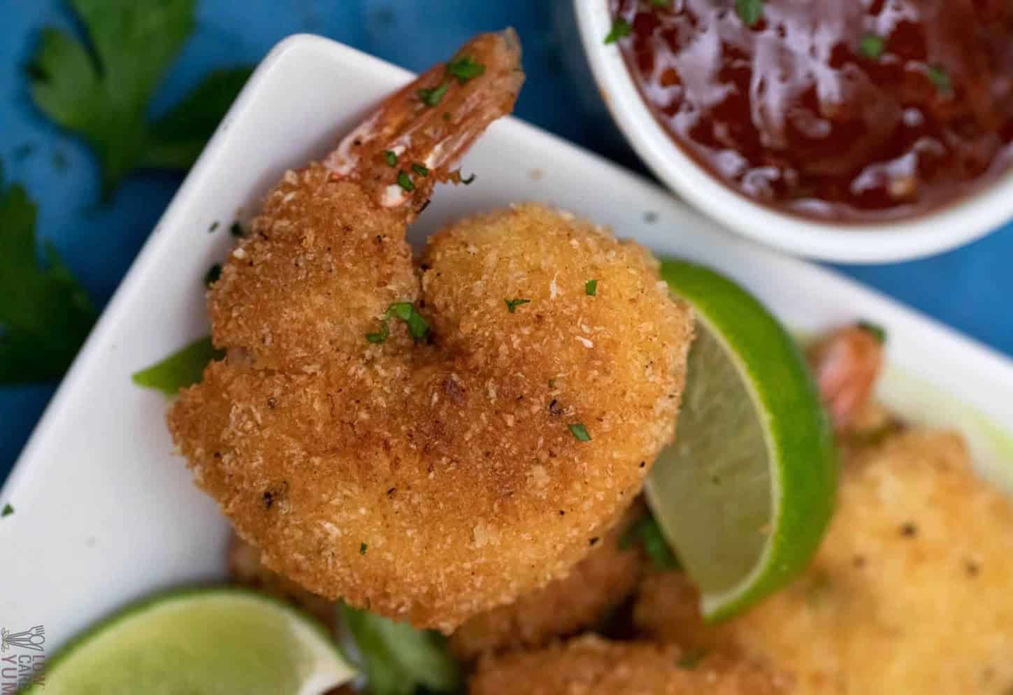 Coconut shrimp with some wedges of lime.