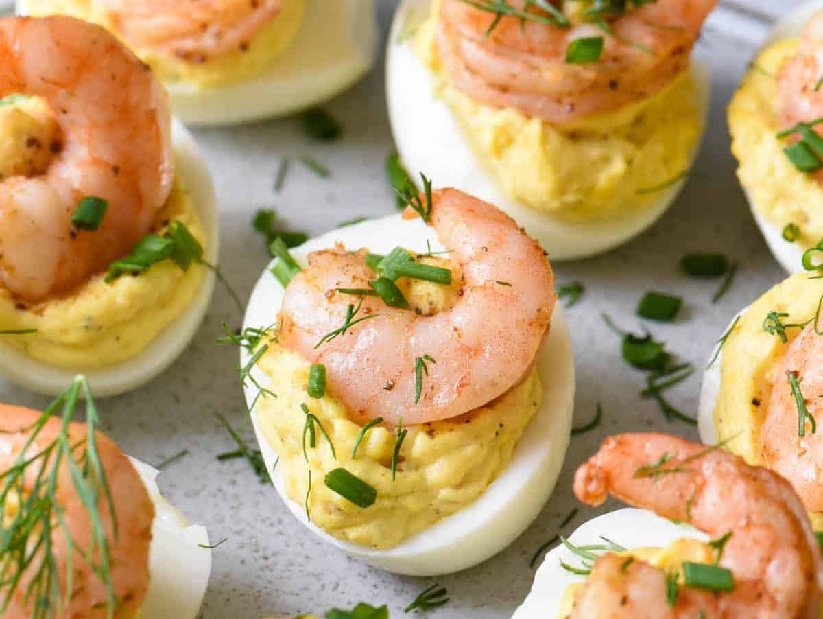 Shrimp Deviled Eggs appetizer for boating on a white plate.