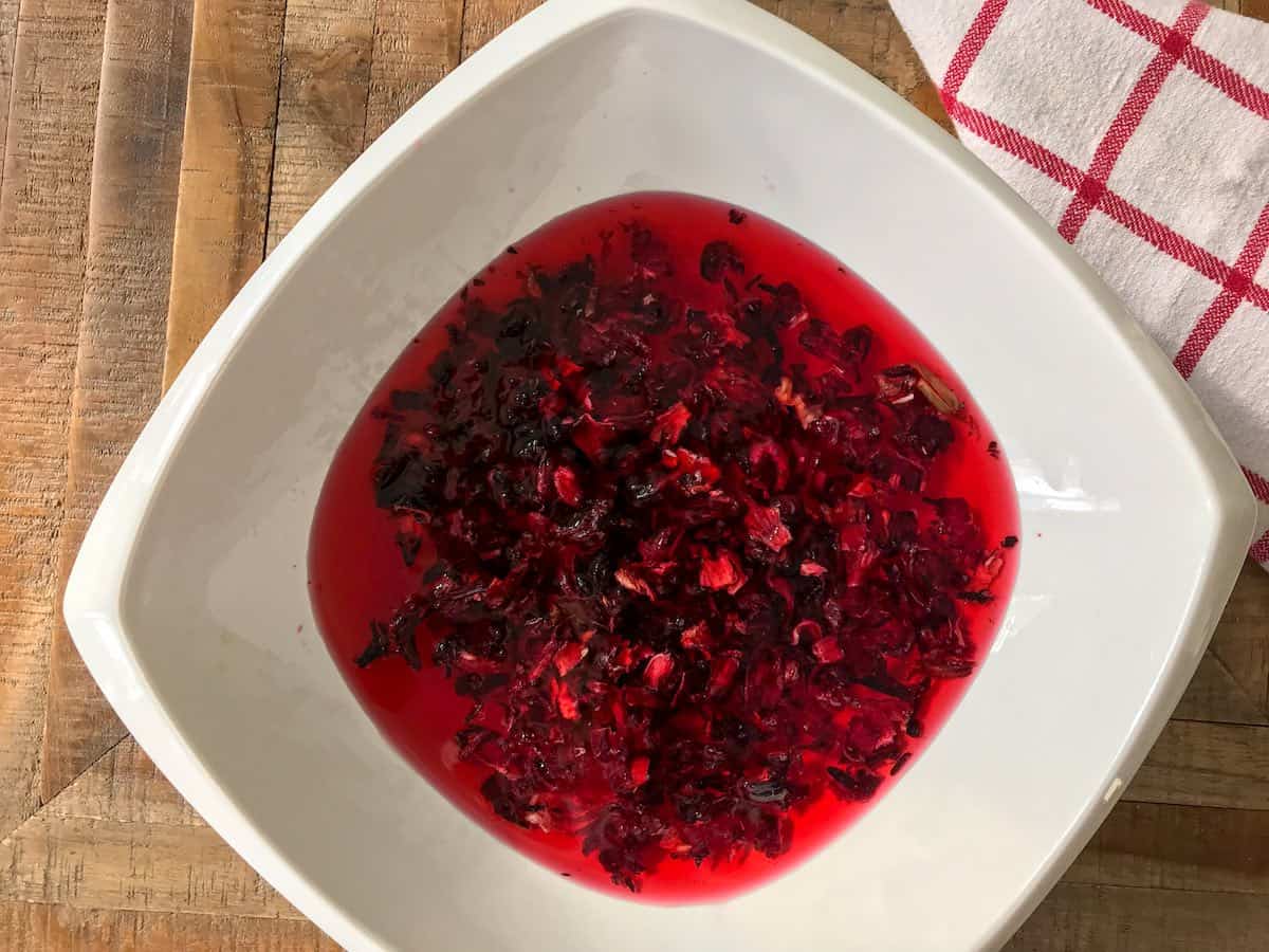 Cold brew method of soaking hibiscus flowers in cold water in a bowl.