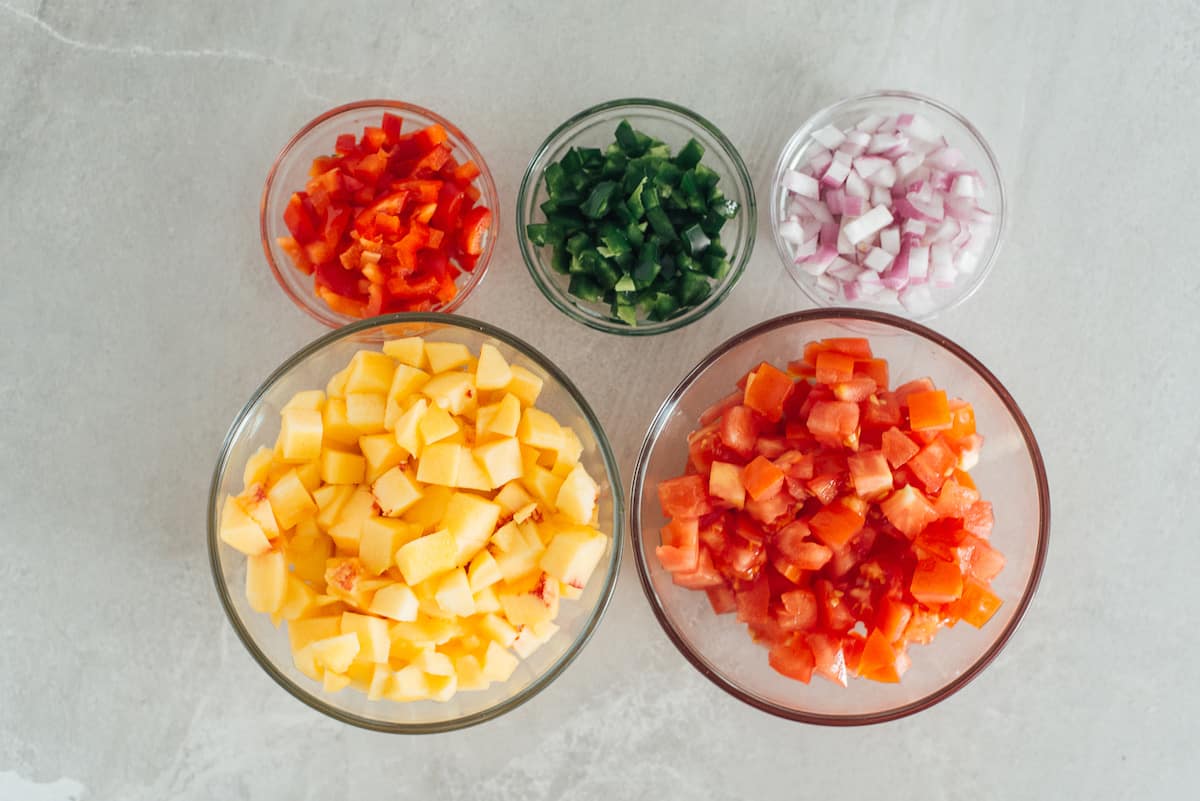 chopped fruit and vegetables in bowls.