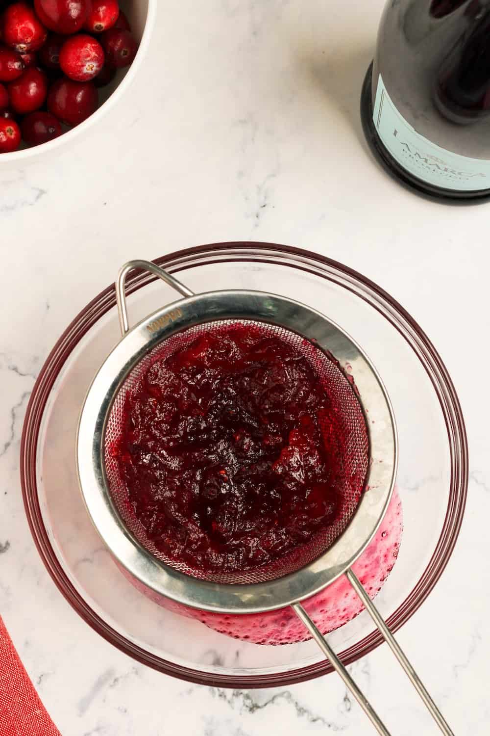 Cooked cranberries in a sieve. .