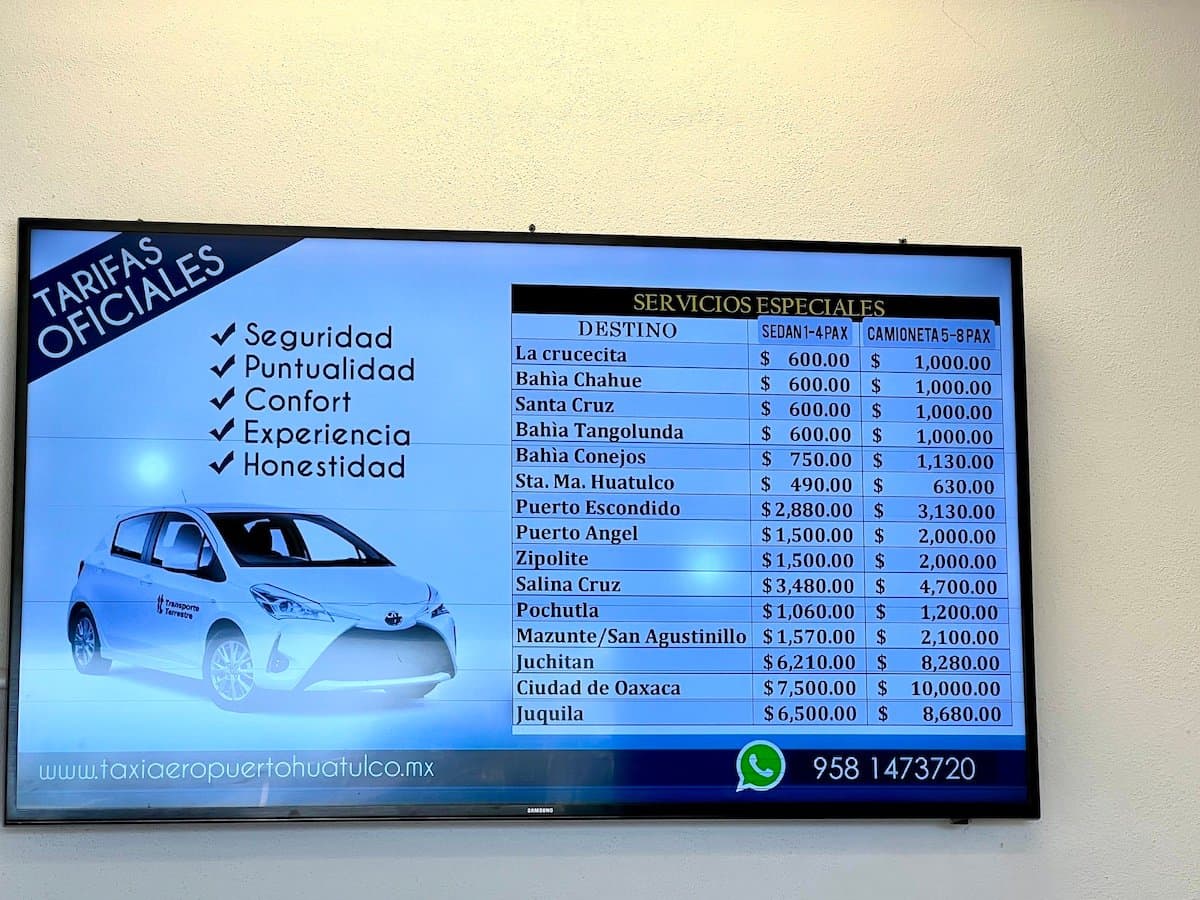 Sign of official taxi prices in Huatulco Airport January 2025.