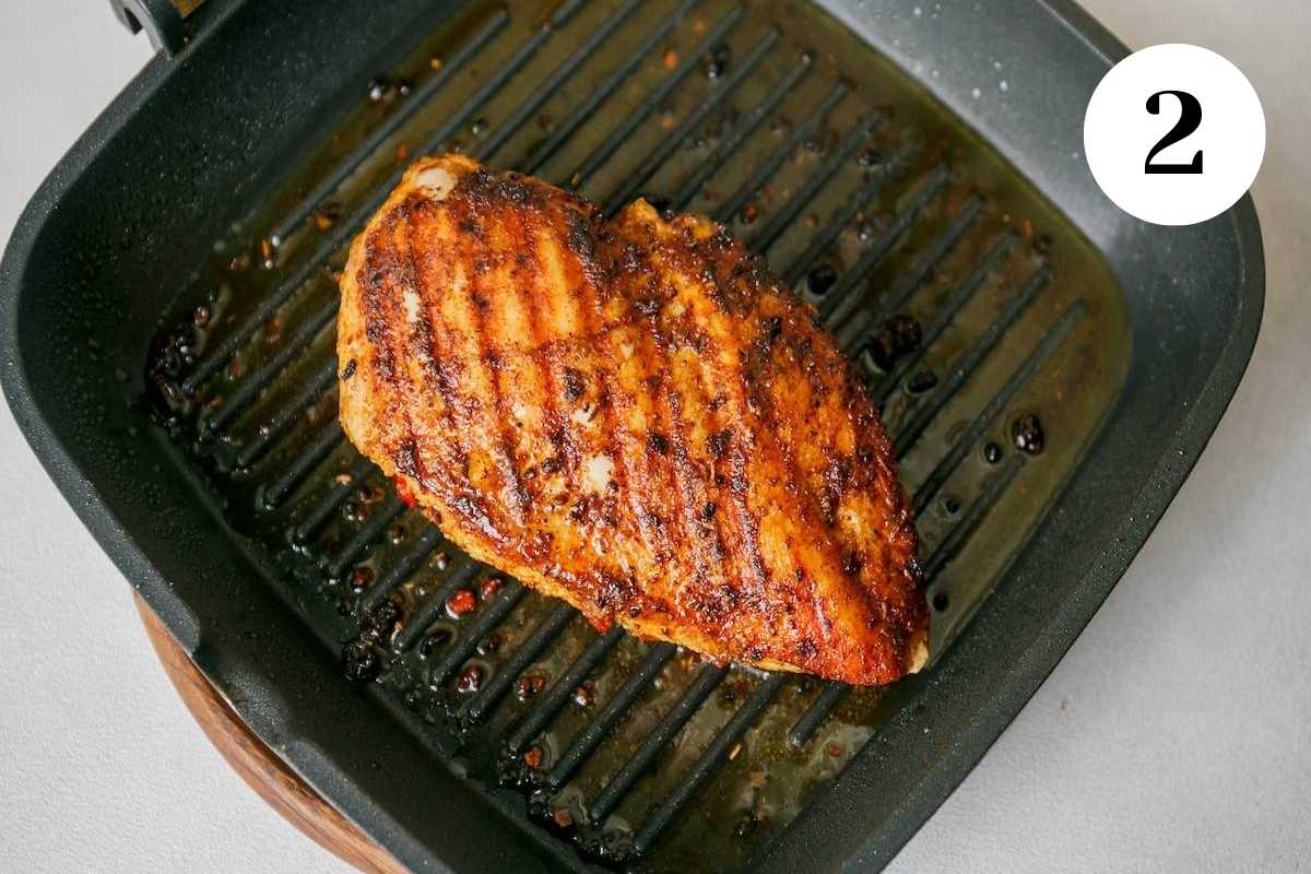 Chicken grilling in a cast iron grill pan.