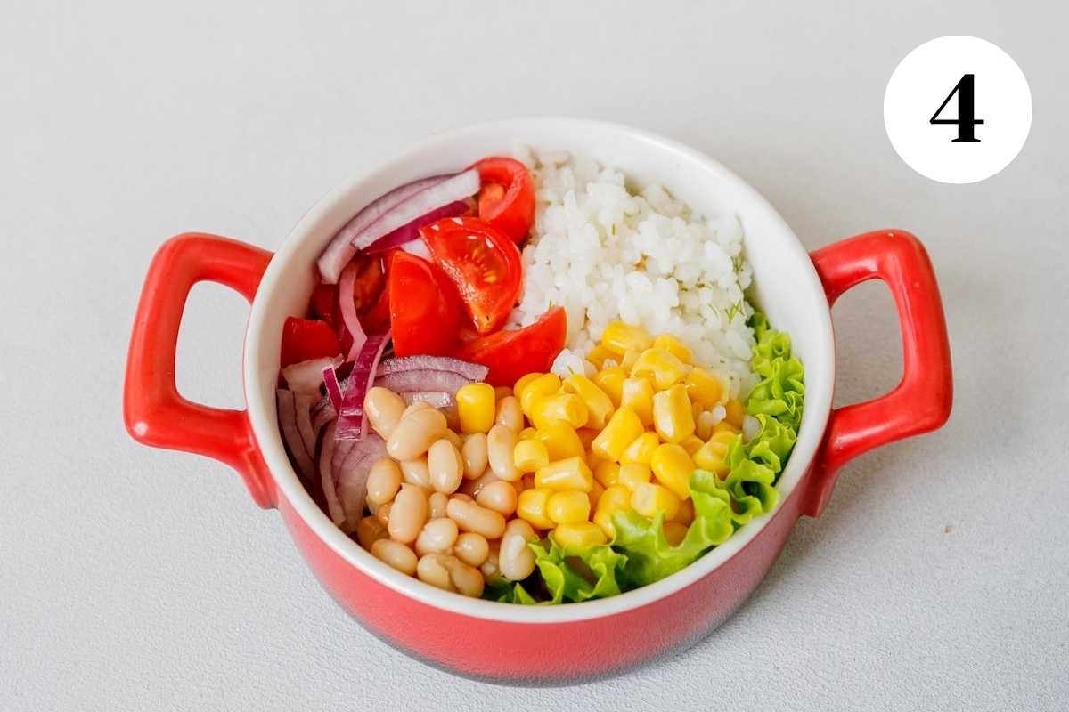 Ingredients for a chicken chipotle burrito bowl in a red bowl.