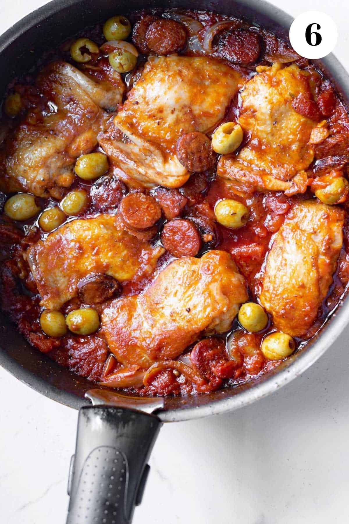 Pollo guisado Guatemalteco in a cast iron pan.