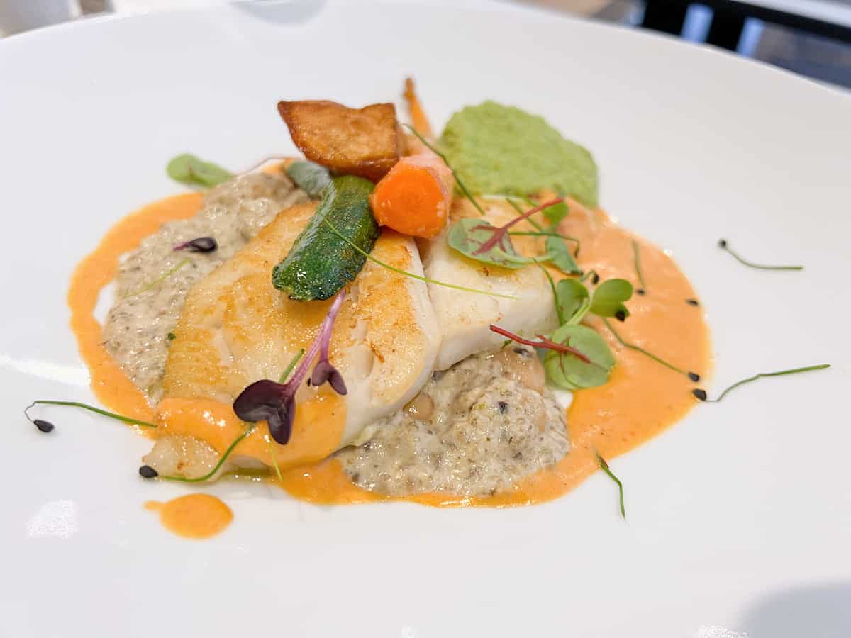Seared halibut on a white plate. 